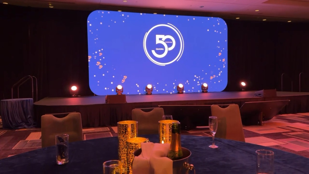 Quadra 50th anniversary stage in Montreal with LED screen and uplighting